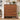 Wooden shoe cabinet with two drawers and shoe compartments in a room setting.
