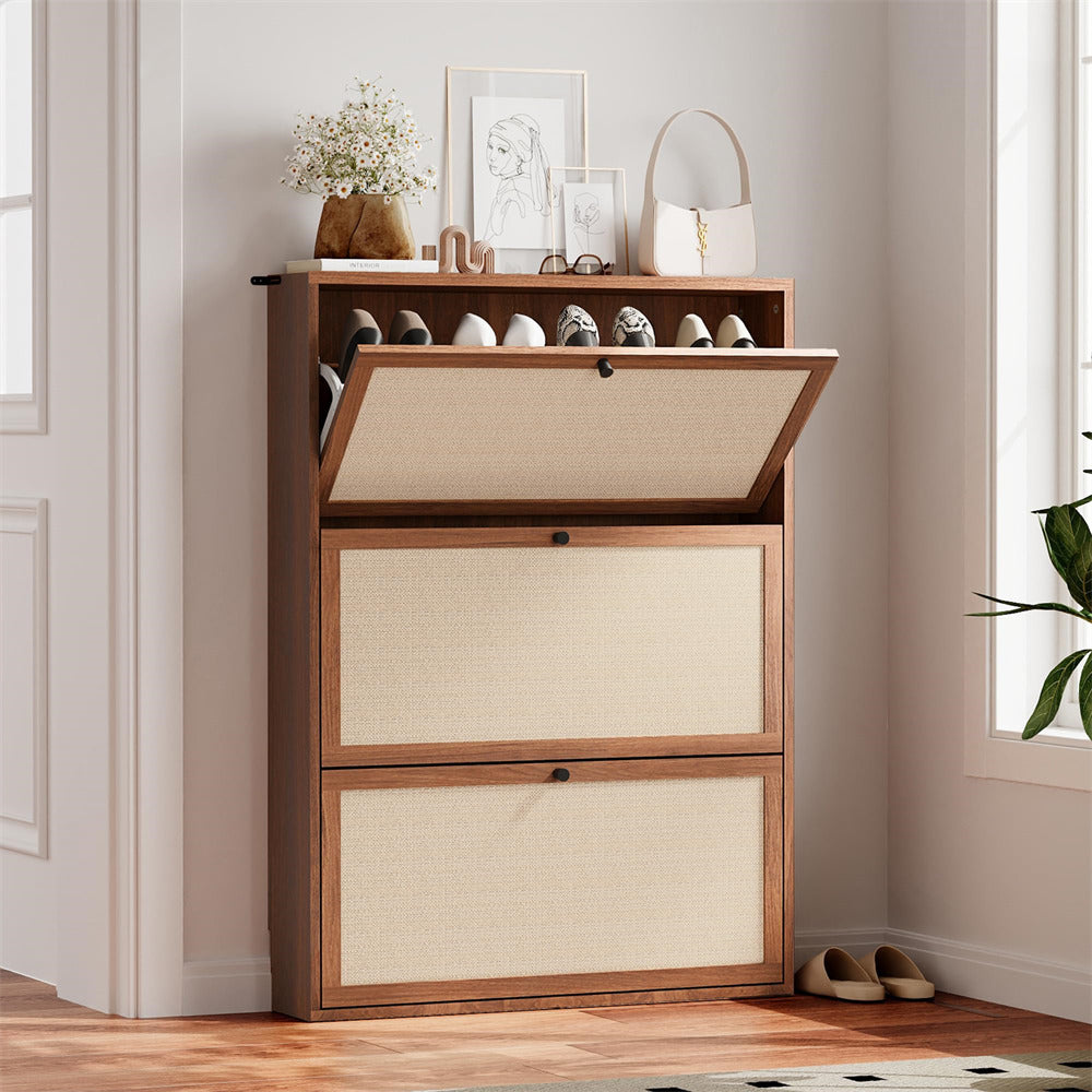Wooden shoe cabinet with open door revealing shoes, placed in a room with light-colored walls and a window.