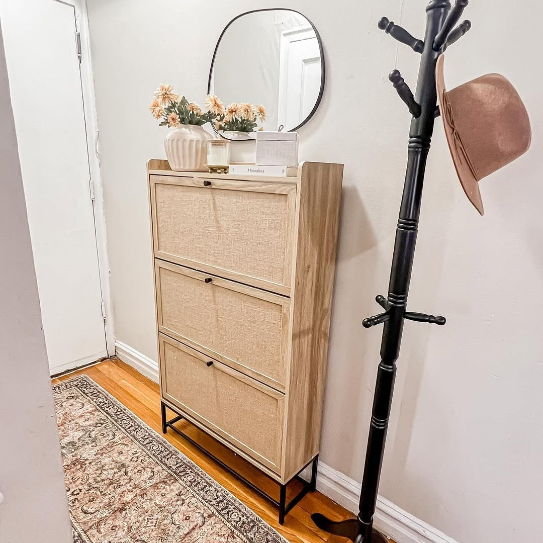 Wooden shoe cabinet with decorative items in a hallway