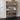 Wooden shoe rack with various shoes on shelves against a white wall.