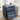Blue nightstand with open drawer in a living room setting