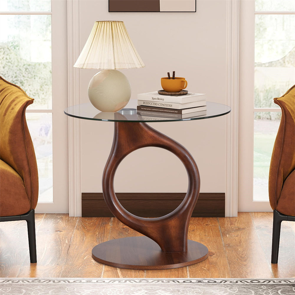Modern side table with glass top and wooden base in a room with chairs and decor.