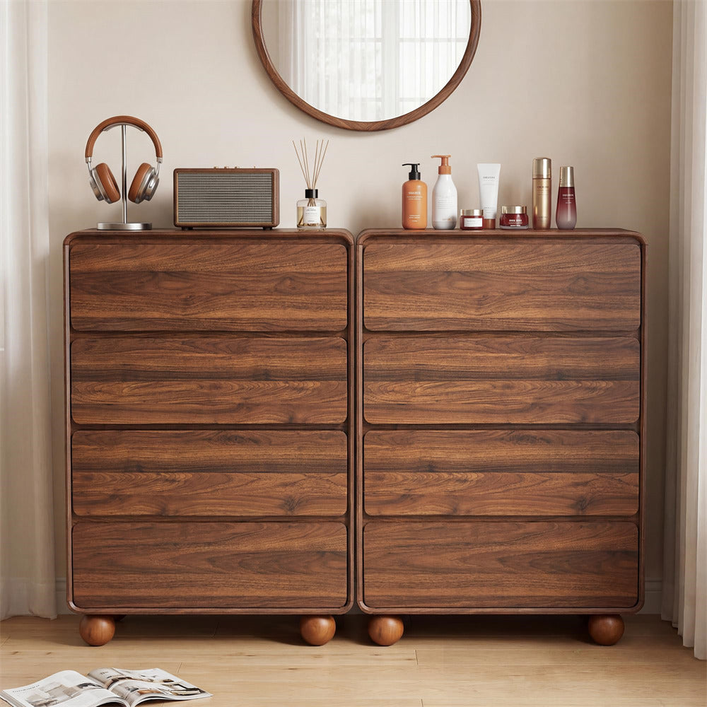 A pair of dark brown wooden 5-drawer chest dressers with rounded feet, styled in a bedroom setting with a round mirror, headphones, a radio, and toiletries on top.