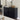 Black sideboard with decorative items in a living room setting