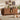 Cat inside a wooden cabinet with another cat on the floor in a living room setting.