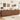 A long mid-century modern wooden sideboard or credenza with scalloped front panels, shown in a styled living room setting with wall art, a clock, shelves, coffee equipment, and a rug.