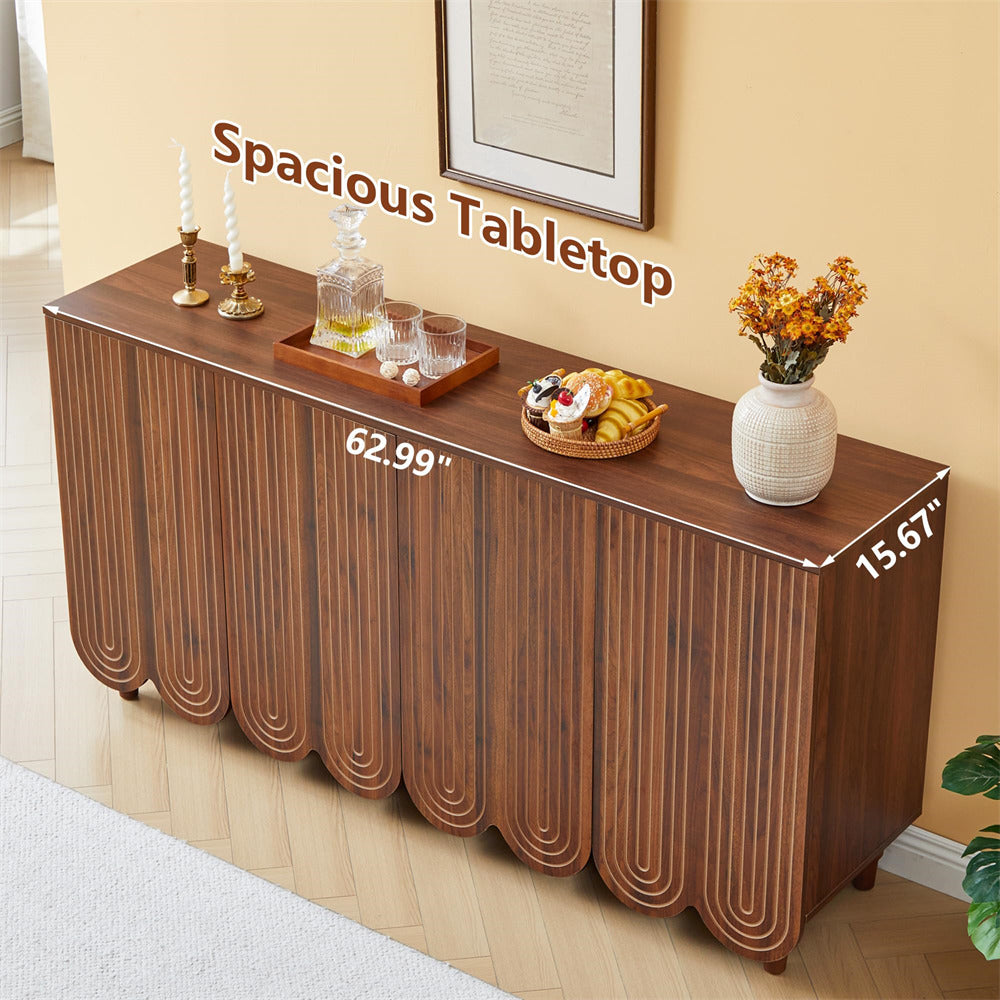 A brown wooden sideboard or console table with a fluted scalloped front and decorative legs, shown in a styled room setting with props on top. White dimension lines and text indicate 62.