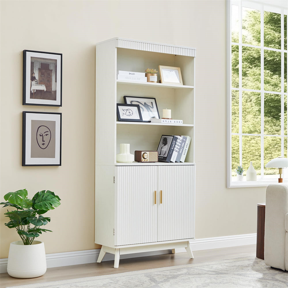 White bookshelf with decorative items in a room with a window and plant.
