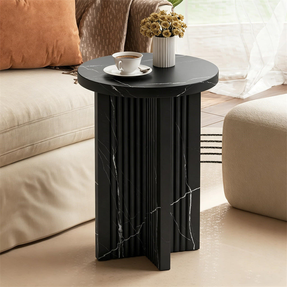 Black marble side table with a cup and saucer in a living room setting