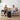 Two women sitting on a couch in a living room, enjoying a cup of coffee.