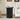 Black marble side table in a living room setting with a couch and decor items.