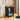 Black side table with wicker design in a living room setting