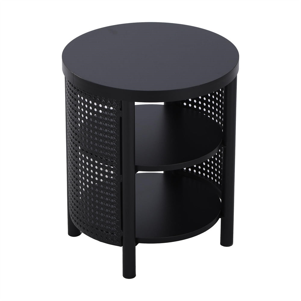 Black round side table with perforated design on a white background