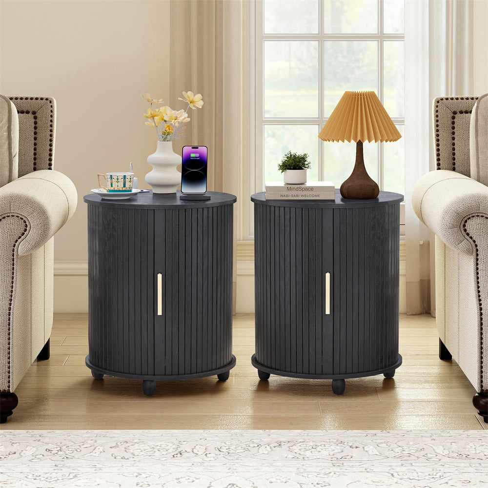 Two dark gray side tables with decorative items in a living room setting.