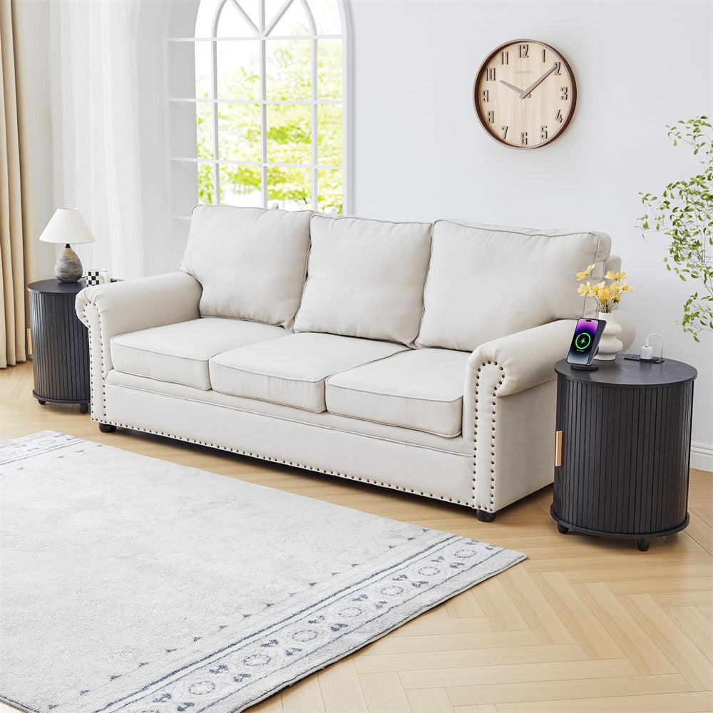 White sofa in a living room with a clock on the wall and a rug on the floor.