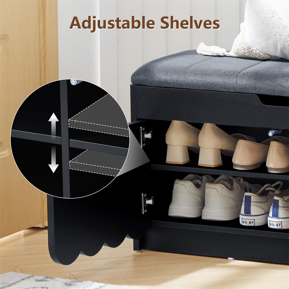 Black shoe cabinet with adjustable shelves containing shoes, shown in a bedroom setting.