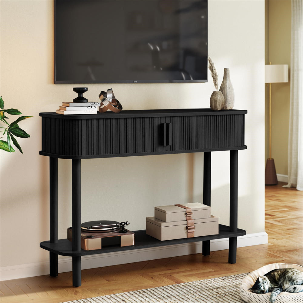 Black console table in a living room with decor items on shelves