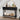 Black console table with decorative items in a room with a staircase.