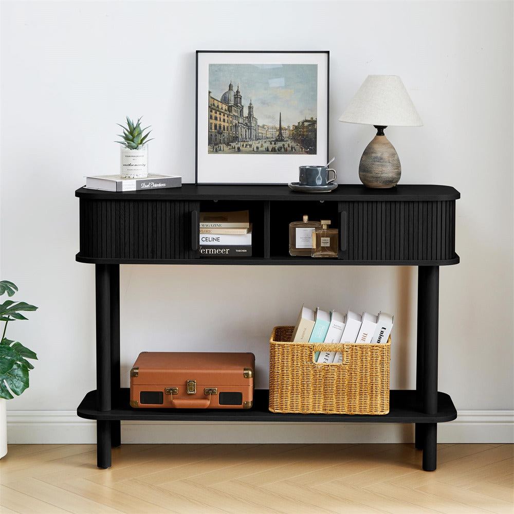 Black console table with decorative items against a white wall