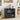 Black cabinet with glass doors displaying items in a room with a plant and dining table.