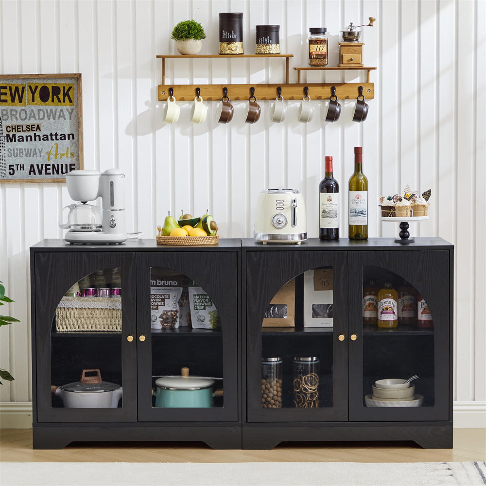 Black sideboard with glass doors displaying kitchen items in a home setting.
