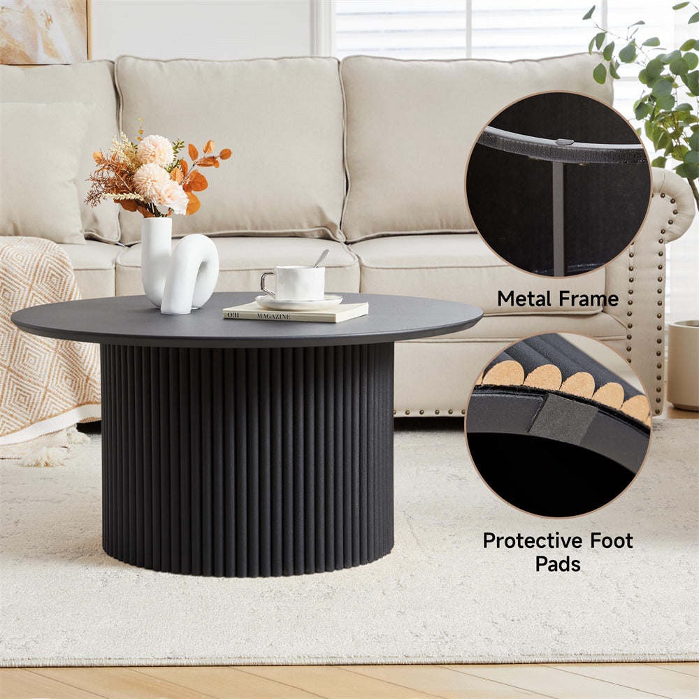 Black coffee table with metal frame and protective foot pads in a living room setting.