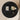 Round black marble table with decorative items on a beige background