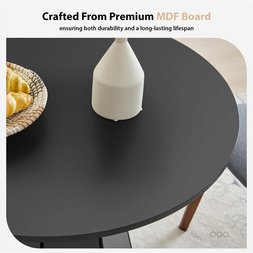 Round black table with a white vase and woven basket on a light-colored floor.