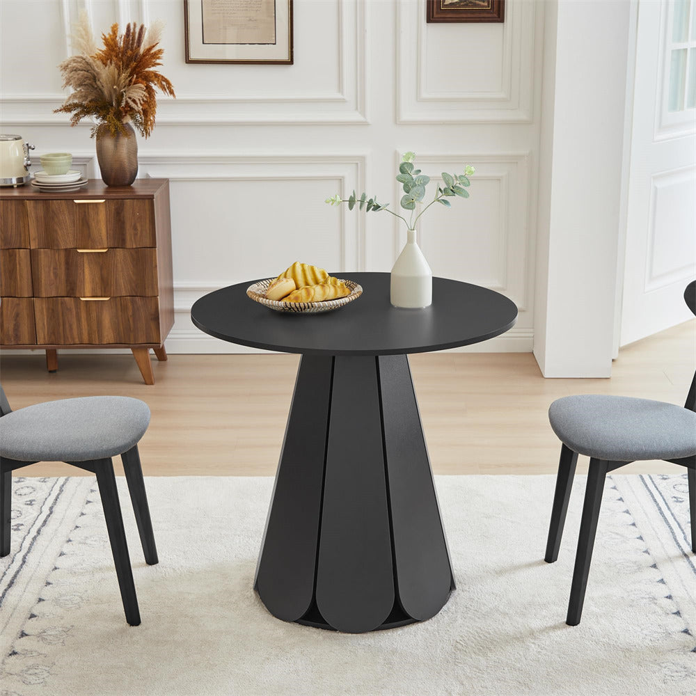 Black round table with decorative items in a living room setting