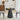 Black round table with decorative items in a living room setting