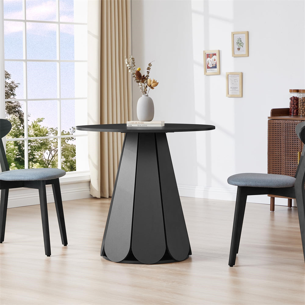 Modern black dining table with two chairs in a bright room with large windows.