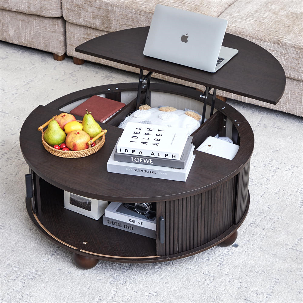 Round coffee table with lift-top feature, books, fruits, and a laptop on a light gray floor.