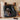 Black entertainment console with record players, speakers, and records on a wooden floor.
