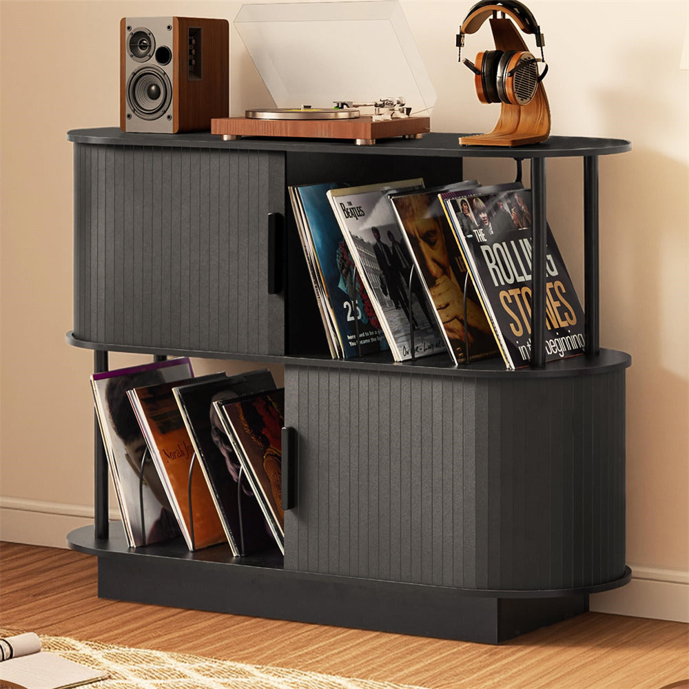 Black record player stand with vinyl records, a turntable, and speakers on a wooden floor.
