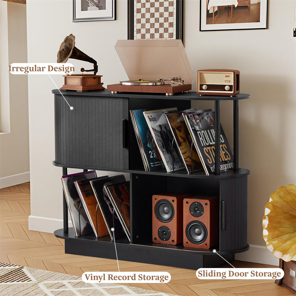 Black storage unit with vinyl records, speakers, and a record player in a room.