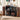 Music-themed room with record players, speakers, and vinyl records on a shelf.