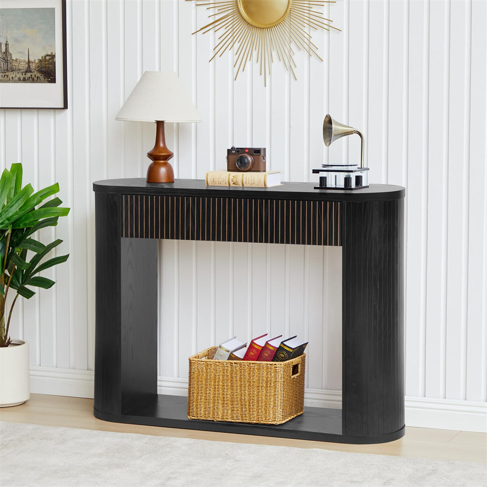Black console table with decorative items against a white wall.