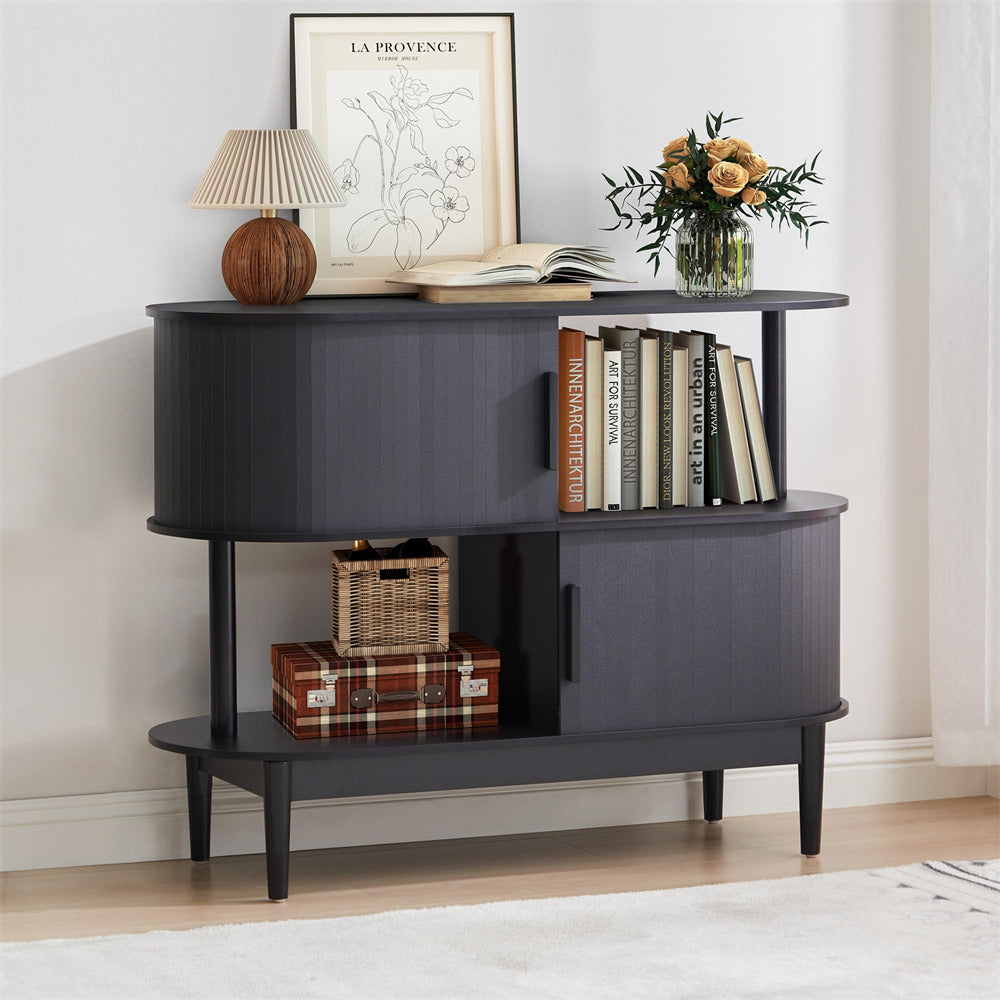 Dark wood sideboard with books, a lamp, and decorative items in a room.