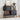Dark wood sideboard with books, a lamp, and decorative items in a room.