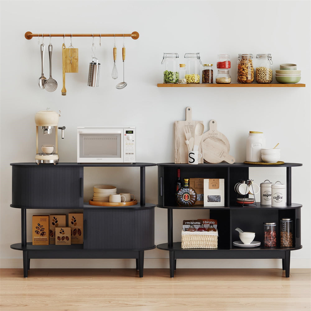 Black kitchen island with shelves, appliances, and cookware against a white wall.