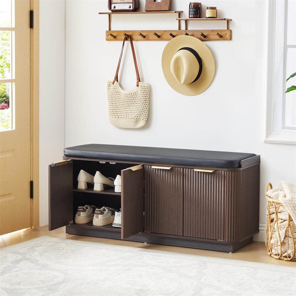 Entryway with a storage bench, shoes, a hat, and a bag.