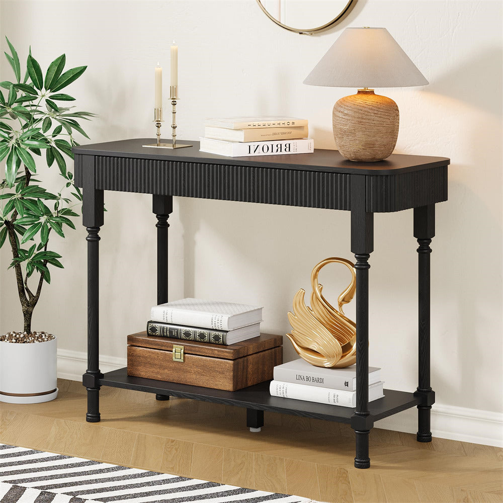 Black console table with decorative items in a room setting