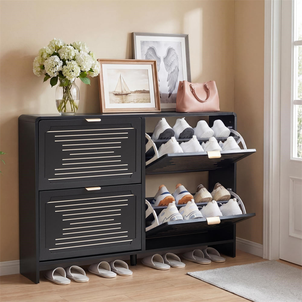 Black shoe cabinet with open doors displaying shoes, a vase of flowers, and framed pictures on top.