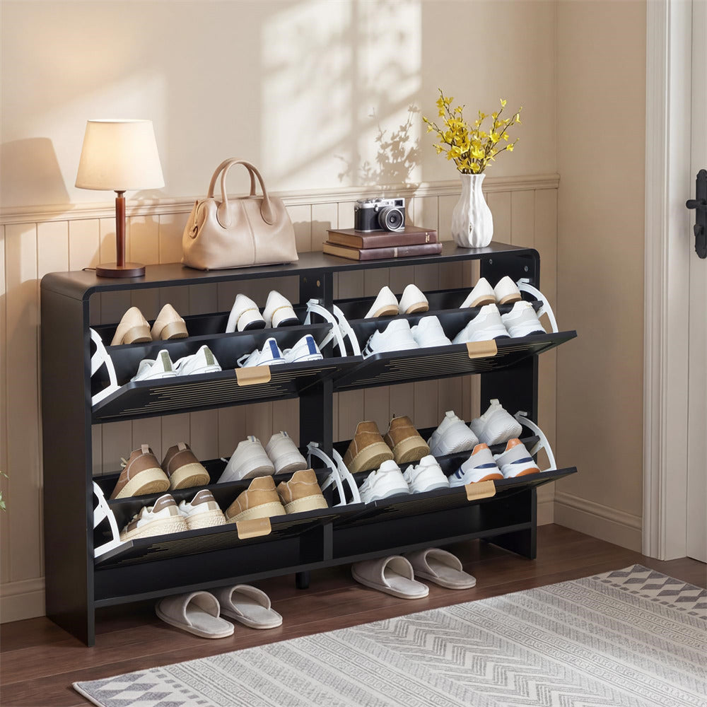 Shoe rack with various shoes on a wooden floor in a room with a lamp and books.