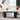Modern living room with a white sofa, black coffee table, and decorative elements.