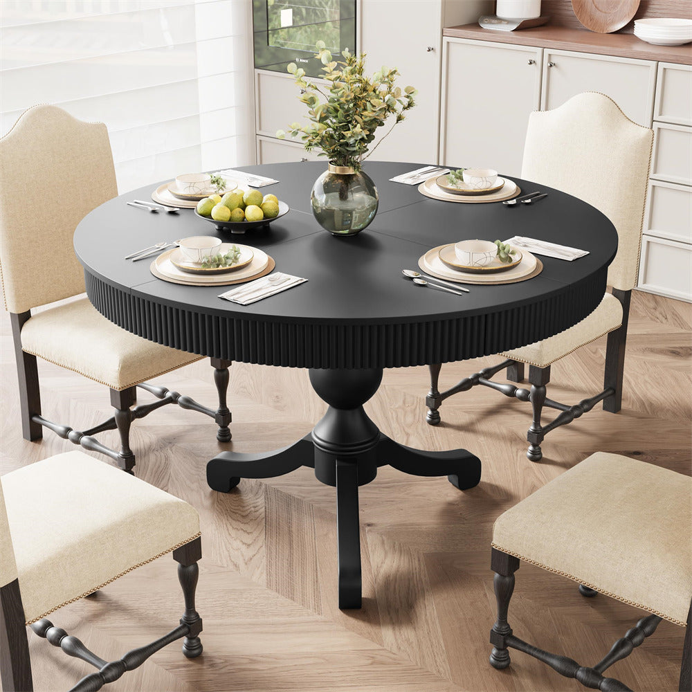 Round black dining table with chairs in a well-lit room