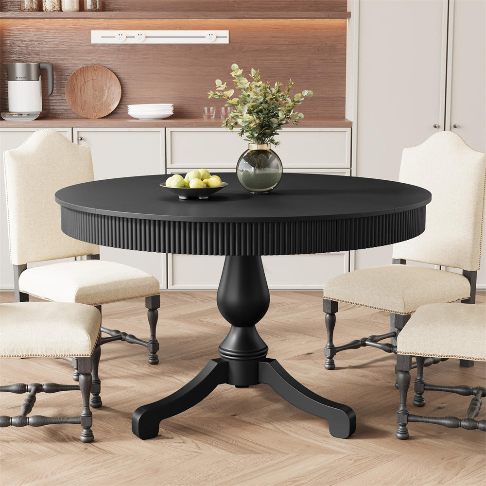 Round black dining table with chairs in a room setting