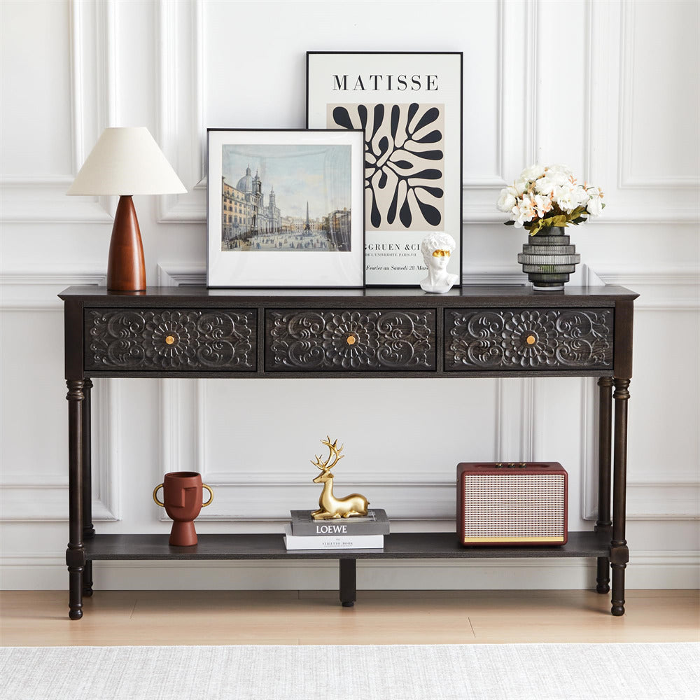 Decorative console table with various items against a white wall