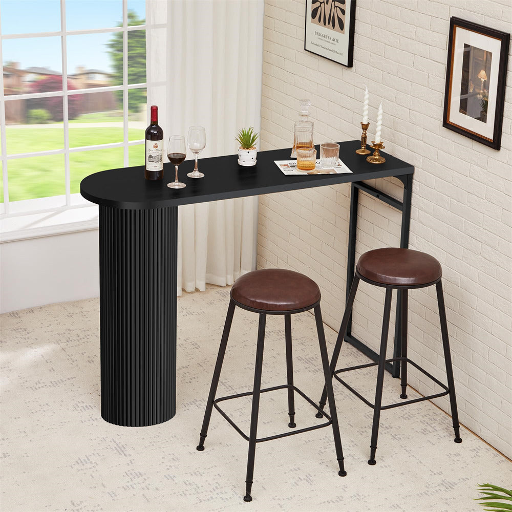 Black bar table with two brown stools in a room with a window view.