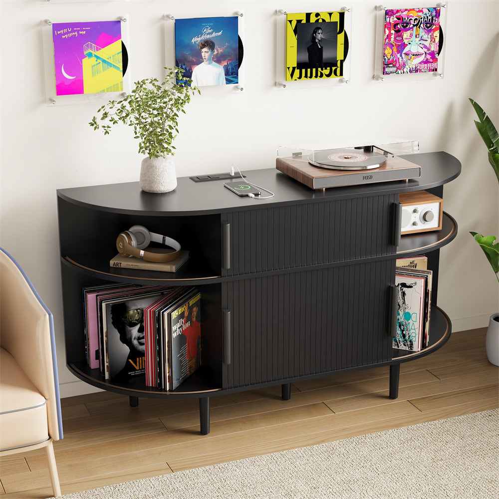 Black entertainment console with records and a turntable in a room with vinyl records on the wall.